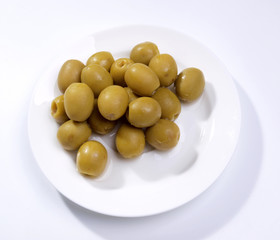 Green olives on fork