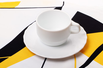 White cup on the tablecloth