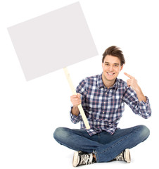 Young man holding blank poster