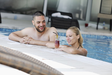 happy cople relaxing  at swimming pool