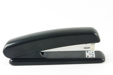 Black stapler on white surface