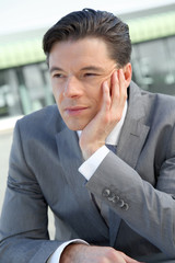 Portrait of businessman standing outside the office