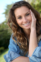 Fototapeta premium Portrait of beautiful woman relaxing in home garden