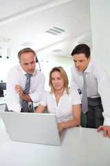 Business meeting in front of laptop computer