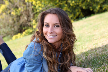 Fototapeta premium Portrait of beautiful woman relaxing in home garden