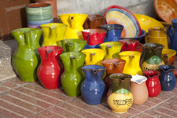 Colorful souvenir jugs for sale outside shop in Majorca, Spain