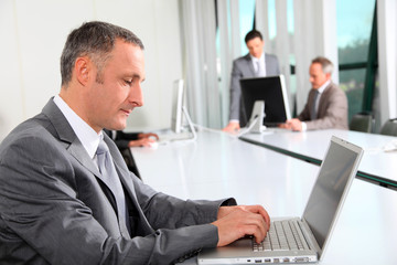 Businessman working on laptop computer in office