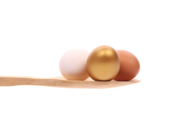 Eggs  on a wooden spoon isolated on a white background