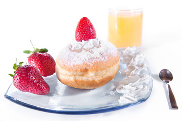 Delicious freshly baked donut with cream and strawberry