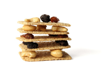 Stack of slices crispbread with nuts, raisins and cereals