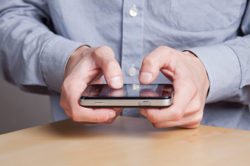 hands of a young man gaining on the phone message