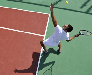 Rolgordijnen young man play tennis outdoor © .shock