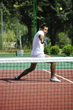 young man play tennis outdoor