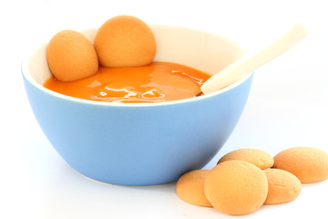 Red bowl with children fruit pap / mush with sponge-biscuits