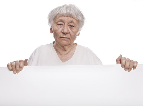 Serious Senior Woman Holding A Blank Sign