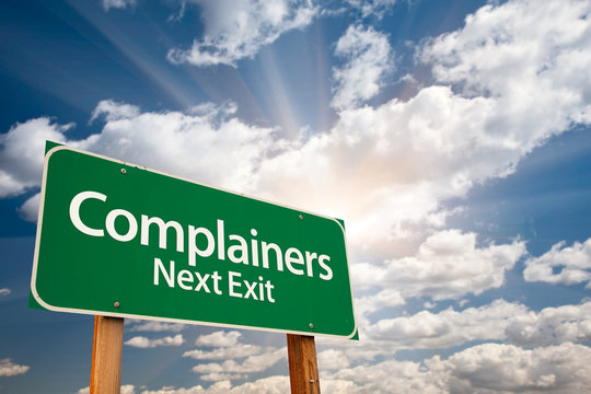 Complainers Green Road Sign and Clouds