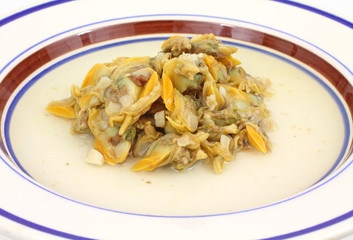 Clams on plate in broth