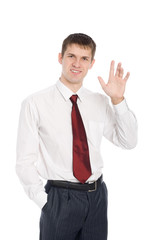 Smiling young businessman with a welcoming gesture