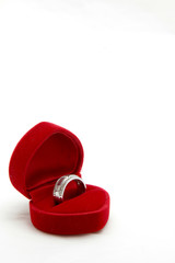 isolated male diamond ring in red velvet box.
