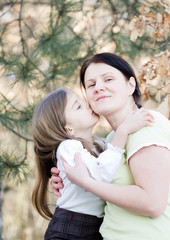 Fototapeta premium Mother and daughter have fun - doughter kiss mother