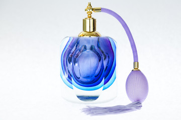 Perfune and necklace isolated over white