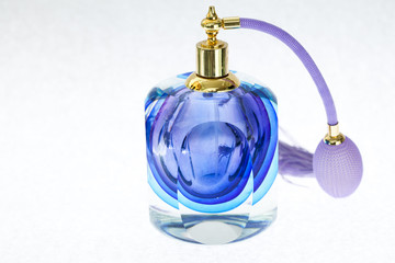 Perfune and necklace isolated over white