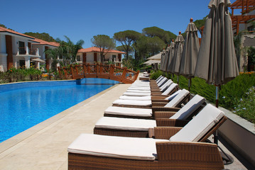 Beautiful poolside with line of chaise longues