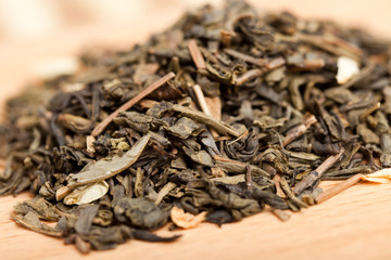 Green tea with jasmine on a wooden board