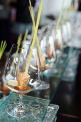 Small  snacks covered with cognac snifters