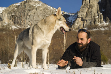 Man and his Czechoslovakian wolf dog © Dmytro Surkov