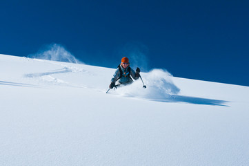mature woman skiing un tracked powder snow