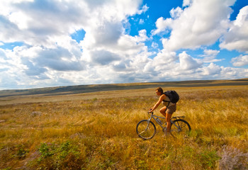 Fototapeta na wymiar Women with bike on meadow