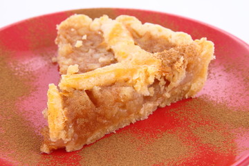 Apple Pie - a slice on a plate decorated with cinnamon