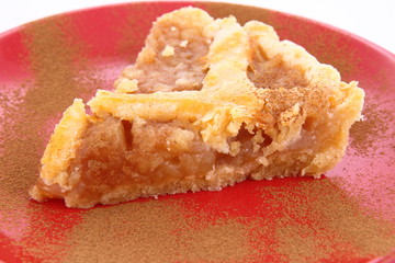 Apple Pie - a slice on a plate decorated with cinnamon