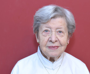 Portrait of Senior Woman in Front of Red Wall
