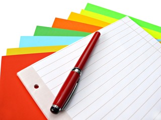 Copybook and pen on colorful papers