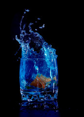 Orange in blue water splash