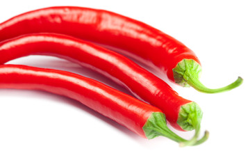 juicy red chili peppers isolated on white