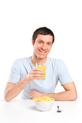 A smiling young man at breakfast