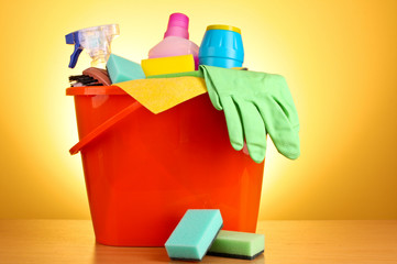 Cleaning supplies on red background
