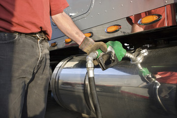 Man fueling Up a Freight Transport Truck