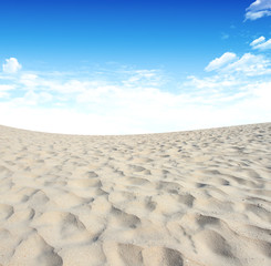 Sand and sky with clouds and sun background .