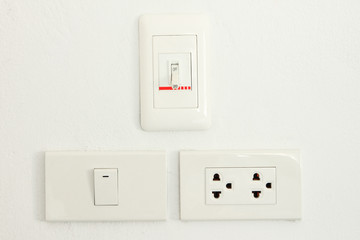 Three type switch on white wall.