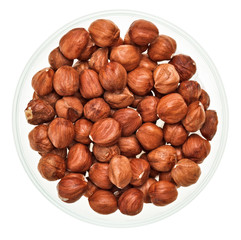 Unshelled hazel nuts in a glass bowl
