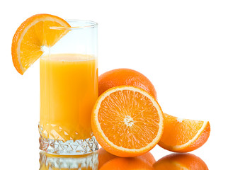 Fresh orange and fresh orange juice in a glass