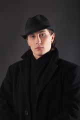 Fototapeta na wymiar Man in black cloth and hat