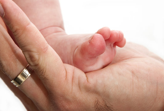 Baby leg in father's hand