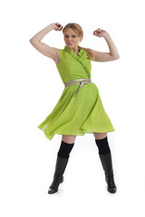 Happy young female in green dress isolated