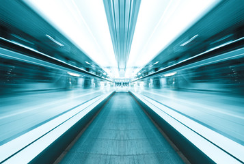 symmetric moving blue escalator inside contemporary airport