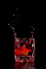 Orange in red water splash
